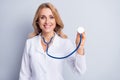 Photo of mature positive smiling cheerful doctor woman hold stethoscope listen breathing isolated on grey color Royalty Free Stock Photo