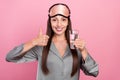 Photo of mature woman happy positive smile drink water show thumb-up recommend ad isolated over pink color background Royalty Free Stock Photo