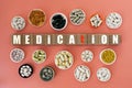 Photo on medication theme. wooden cubes with the inscription `medication`, and biologically active supplements,on coral background