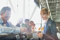 Portrait of man giving his passport for check in with passenger service agent at airport Royalty Free Stock Photo