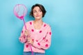 Photo of minded lovely cute girl hands hold butterfly net look interested empty space isolated on blue color background Royalty Free Stock Photo