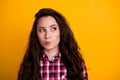 Photo of minded smart woman with wavy hairdo dressed checkered shirt thoughtfully look at empty space isolated on yellow