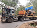 Photo of a mini JCB loded on a truck