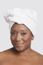 Portrait of mixed race woman with towel wrapped on head over white background