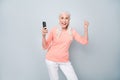 Photo of modern cool delightful nice glad positive optimistic lovely old lady raising fist up using telephone isolated