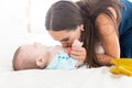 Mom kisses her baby in the small belly