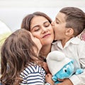 Photo mother daughter and son. children kiss their mother. Emotional photo.