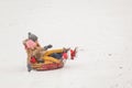 Photo of mother with daughter and son riding on tubing in snowfall Royalty Free Stock Photo