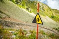 Photo of mountain slope and warning sign