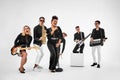 Photo of multi ethnic music band in studio.Musicians and woman soloist posing over white background Royalty Free Stock Photo