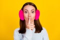 Photo of mute voiceless young woman wear earmuff hold finger lips mouth isolated on yellow color background Royalty Free Stock Photo