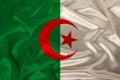 Photo of the national flag of algeria on a luxurious texture of satin, silk with waves, folds and highlights, closeup, copy space Royalty Free Stock Photo