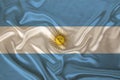 Photo of the national flag of Argentina on a luxurious texture of satin, silk with waves, folds and highlights, close-up, copy