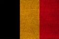 Photo of the national flag of Belgium on a luxurious texture of satin, silk with waves, folds and highlights, close-up, copy space Royalty Free Stock Photo