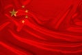 Photo of the national flag of China on a luxurious texture of satin, silk with waves, folds and highlights, closeup, copy space, Royalty Free Stock Photo