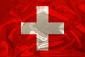 Photo of the national flag of Switzerland on a luxurious texture of satin, silk with waves, folds and highlights, closeup, copy Royalty Free Stock Photo