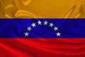 Photo of the national flag of Venezuela on a luxurious texture of satin, silk with waves, folds and highlights, close-up, copy