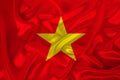 Photo of the national flag of Vietnam on a luxurious texture of satin, silk with waves, folds and highlights, close-up, copy space