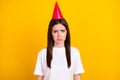 Photo of negative mood unhappy upset girl wear hat cone feeling lonely at birthday party isolated on yellow color