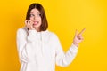 Photo of nervous lady biting finger direct empty space look side wear white hoodie isolated yellow color background