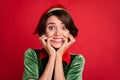 Photo of nervous scared crazy lady teeth bite fingers wear elf costume hat isolated red color background