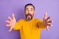 Photo of nervous scared man stretch hands camera open mouth wear yellow pullover isolated violet background Royalty Free Stock Photo