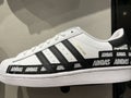 Photo of the New 2021 Mens Superstar White Adidas with black stripes on shelf