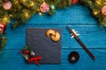 Photo of New Year branches of fir, black board, sticks for sushi, cookies with prediction Royalty Free Stock Photo