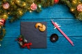 Photo of New Year branches of fir, black board, sticks for sushi, cookies with prediction Royalty Free Stock Photo