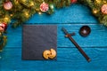 Photo of New Year branches of fir, black board, sticks for sushi, cookies with prediction Royalty Free Stock Photo