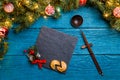 Photo of New Year branches of fir, black board, sticks for sushi, cookies with prediction Royalty Free Stock Photo