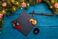 Photo of New Year branches of fir, black board, sticks for sushi, cookies with prediction Royalty Free Stock Photo