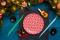Photo of New Year branches of fir, black board, sushi sticks, prediction cookies, Royalty Free Stock Photo