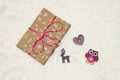 Photo of a New Year`s gift in craft packaging with a felt toy owl