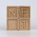 Photo on NFT non-fungible token theme. Wooden cubes with the abbreviation NFT, on white background