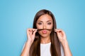 Photo of nice adorable girl make jokes fake mustache with hair curl isolated pastel color background Royalty Free Stock Photo