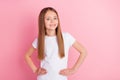 Photo of nice blond little girl wear white t-shirt isolated on pink color background Royalty Free Stock Photo