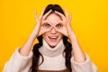 Photo of nice brunette optimistic curly hairdo lady show hands spectacles wear sweater isolated on yellow color