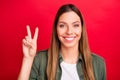 Photo of nice cheerful enjoying overjoyed woman giving you v-sign while isolated with red background