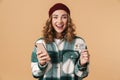 Photo of nice cheerful woman holding credit card and cellphone