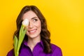 Photo of nice creative minded girl tulip flower cover one eye look empty space isolated on yellow color background