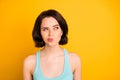 Photo of nice cute cunning sly girl serious pondering over something while isolated with yellow background Royalty Free Stock Photo
