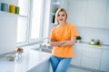 Photo of nice girl crossing hands advertise new apartments standing in modern dining room kitchen Royalty Free Stock Photo