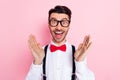 Photo of nice impressed brown hair guy wear spectacles white shirt isolated on pastel pink color background Royalty Free Stock Photo