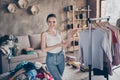 Photo of nice lovely happy girl wearing denim jeans standing showing her design collection of clothes in new flat house. Royalty Free Stock Photo