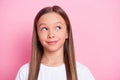 Photo of nice optimistic blond girl look empty space wear white t-shirt isolated on pink color background Royalty Free Stock Photo