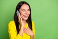 Photo of nice person speak phone closed eyes laughing hand on chest isolated on green color background