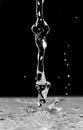 Photo of water trickle and drops on black background