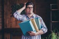 Photo of nice young corporate man hold folders think wear striped shirt loft interior office indoors Royalty Free Stock Photo