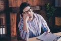 Photo of nice young man sleep work desk wear striped shirt loft interior business center indoors Royalty Free Stock Photo